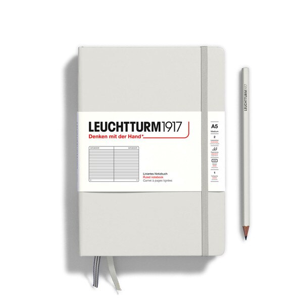 A light gray colored hardcover notebook.